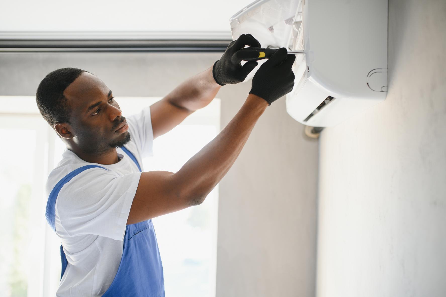 Blitztek HVAC technician repairing indoor air conditioning unit