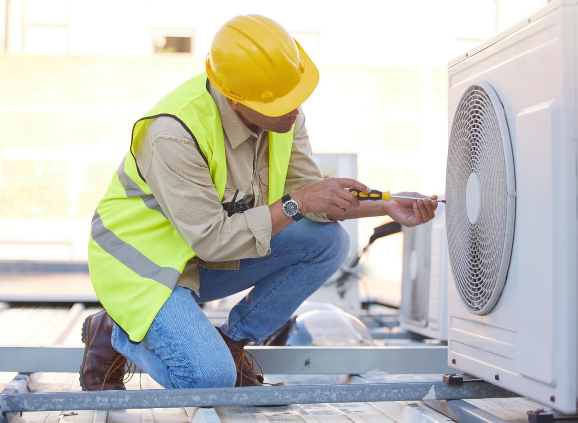 HVAC technician servicing rooftop unit